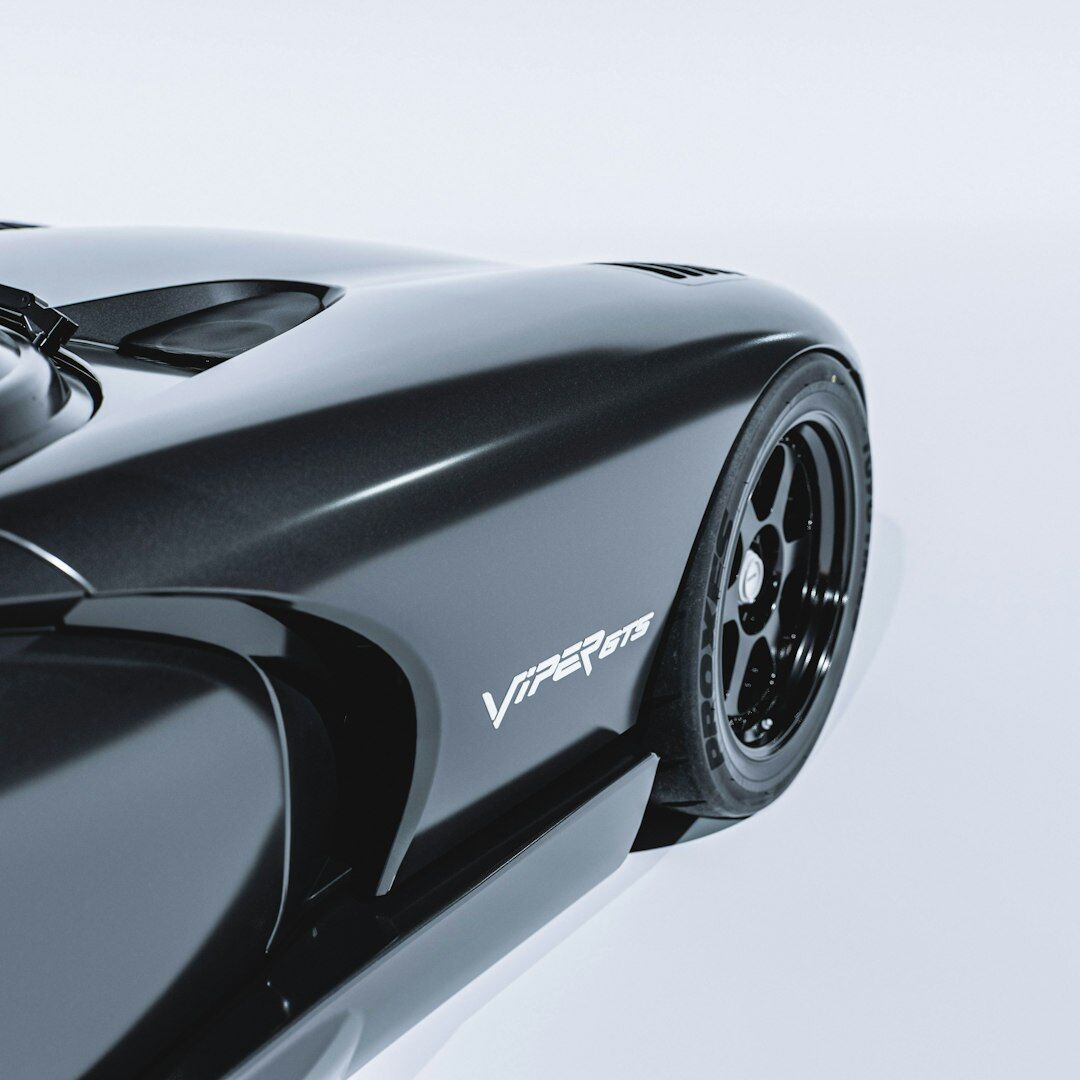 Modern hypercar with a V12 engine photographed in dynamic studio angle