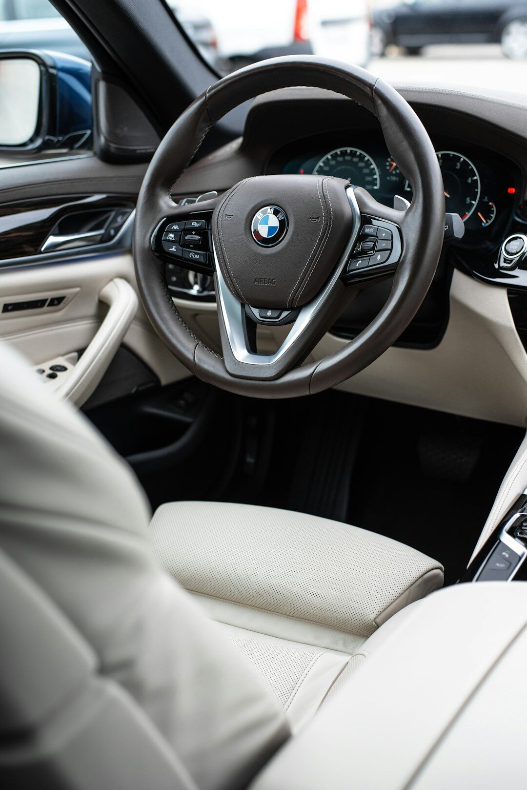 Luxury car interior dashboard detail with leather and steering wheel